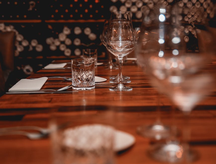glass dining table furniture table tabletop wood hardwood goblet indoors restaurant