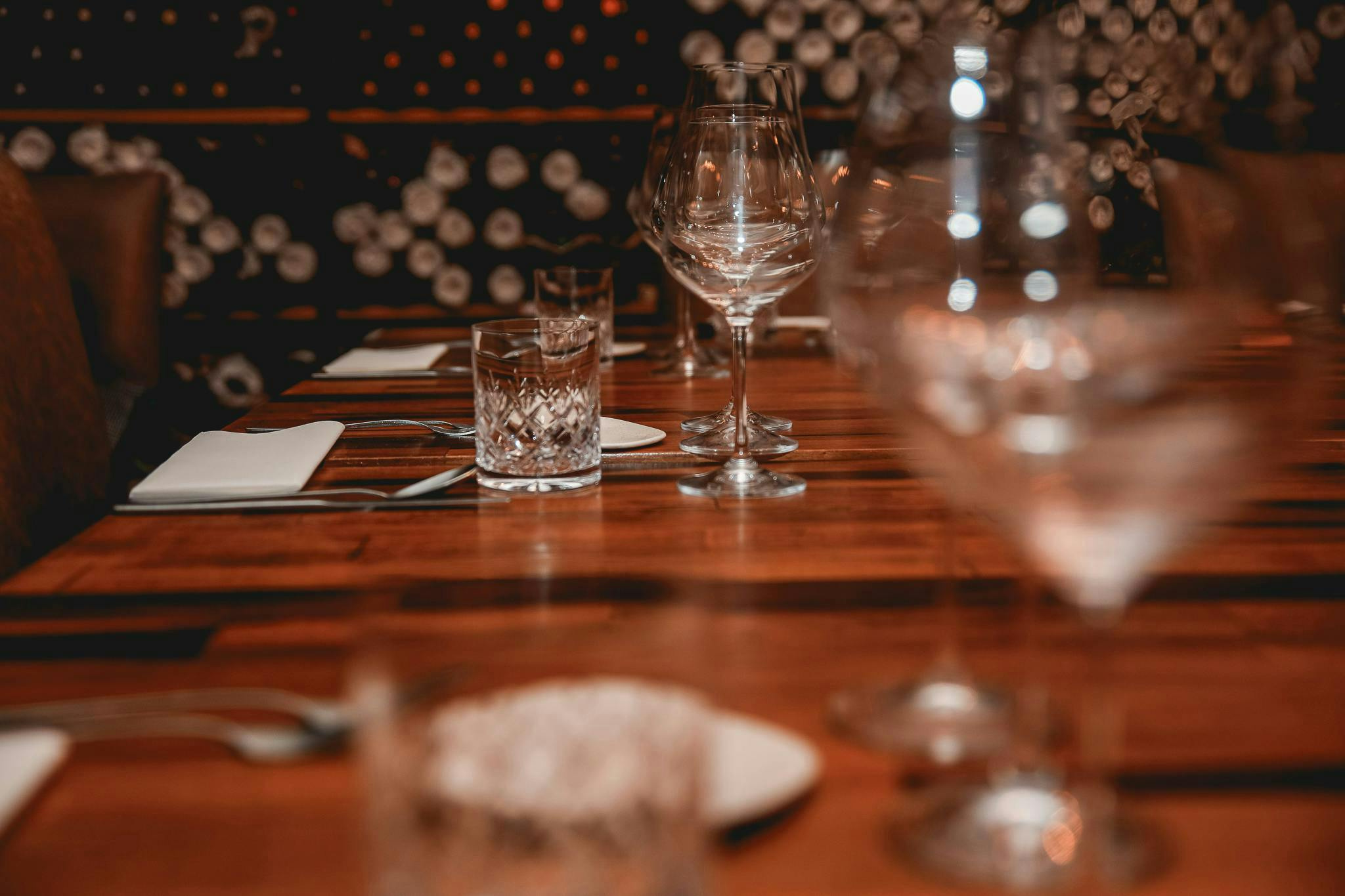 glass dining table furniture table tabletop wood hardwood goblet indoors restaurant